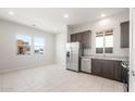 Bright kitchen featuring stainless steel appliances, tile floors, and granite countertops at 18169 E Bronco Dr, Queen Creek, AZ 85142