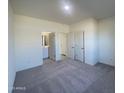 Spacious bedroom with gray carpet, and access to a bathroom at 1963 E Harness Ln, San Tan Valley, AZ 85140