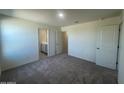 Bright bedroom featuring gray carpet and an ensuite bathroom at 1963 E Harness Ln, San Tan Valley, AZ 85140
