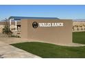 Wales Ranch community entrance sign with landscaping and seating area at 1963 E Harness Ln, San Tan Valley, AZ 85140