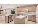 Bright kitchen with light wood cabinets, stainless steel dishwasher, and breakfast bar at 19850 N 110Th Ln, Peoria, AZ 85373