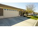 Charming home featuring a stone-accented facade, two-car garage, and well-maintained landscaping at 2663 S Springwood Blvd # 299, Mesa, AZ 85209