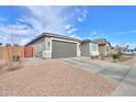 Home exterior with a two-car garage and desert landscaping at 346 E Tahiti E Dr, Casa Grande, AZ 85122