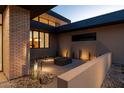 This courtyard features a unique architectural design with a modern fire pit and desert landscaping at 3643 E Coolidge St, Phoenix, AZ 85018
