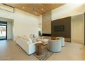 Bright living room featuring high ceilings, a brick fireplace, and stylish modern furniture at 3643 E Coolidge St, Phoenix, AZ 85018