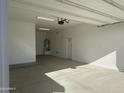 Spacious, clean, and well-lit three car garage interior at 3742 E Rochelle Cir, Mesa, AZ 85213