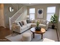 Bright living room with a large sectional sofa, modern art, and sunny windows at 4114 S Sawmill Rd, Gilbert, AZ 85297