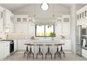 Bright white kitchen with island, stainless steel appliances, and white shaker cabinets at 564 E Aurora Dr, San Tan Valley, AZ 85140