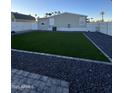 Artificial turf backyard with rock border and privacy fence at 625 W Mckellips Rd # 7, Mesa, AZ 85201