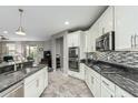 This sleek kitchen is equipped with stainless steel appliances and contrasting mosaic tile backsplash at 7564 W Darrel Rd, Laveen, AZ 85339