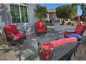 Relaxing patio with red cushioned wicker furniture at 7850 W Discovery Way, Florence, AZ 85132