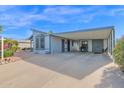 Single wide mobile home with covered parking and desert landscaping at 8500 E Southern Ave # 577, Mesa, AZ 85209