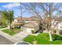 Two-story house with attached garage and grassy front yard at 10024 W Montecito Ave, Phoenix, AZ 85037