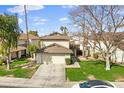Two-story house with attached garage and grassy front yard at 10024 W Montecito Ave, Phoenix, AZ 85037