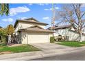 Two-story house with attached garage and grassy front yard at 10024 W Montecito Ave, Phoenix, AZ 85037