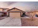 House exterior featuring a tan stucco finish and a two-car garage at 11226 W Calle De La Luna --, Phoenix, AZ 85037