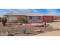 Ranch style home with brick facade and desert landscaping at 11402 N 97Th Dr, Sun City, AZ 85351