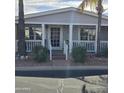 Close up view of a home with a front porch and adorned with shrubs and brick steps at 11411 N 91St Ave # 225, Peoria, AZ 85345