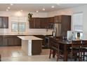 Modern kitchen with island, stainless steel appliances, and dark wood cabinets at 1180 E Marlin Dr, Chandler, AZ 85286