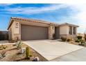 Single-story home with desert landscaping and a two-car garage at 15047 S 178Th Dr, Goodyear, AZ 85338