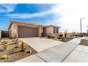 Single-story home with desert landscaping and a two-car garage at 15047 S 178Th Dr, Goodyear, AZ 85338