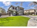 Two-story home with an attached two-car garage and a well-maintained front yard with artificial grass, perfect for easy upkeep at 1578 S Sabino Ct, Gilbert, AZ 85296