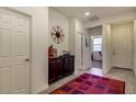 Bright entryway with tile flooring and dark wood cabinet at 16008 N 109Th Dr, Sun City, AZ 85351