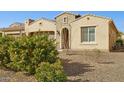 Beautiful single-story home with desert landscaping, brick accents, and an inviting entrance at 16954 W Palm Ln, Goodyear, AZ 85395