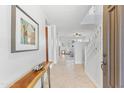 Bright foyer with tile flooring, staircase, and view into the living spaces at 17763 N 93Rd Way, Scottsdale, AZ 85255