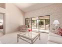 Living room with patio access and a comfy seating arrangement at 19511 N 143Rd Dr, Sun City West, AZ 85375
