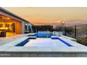 Luxury pool and spa with a fire pit and stunning sunset views at 26686 W Piute Ave, Buckeye, AZ 85396