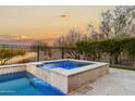 Relaxing spa with waterfall feature and tranquil sunset views at 26686 W Piute Ave, Buckeye, AZ 85396