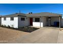 Inviting single-story home featuring a red front door, white exterior, and covered carport at 2724 W Pierson St, Phoenix, AZ 85017