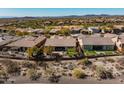 Aerial view of a home showcasing lush landscaping, a patio area, and proximity to the golf course at 41515 N Laurel Valley Way, Anthem, AZ 85086