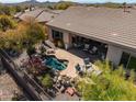 Beautiful backyard featuring desert landscaping, a refreshing pool, and comfortable patio seating at 41515 N Laurel Valley Way, Anthem, AZ 85086