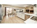 Beautiful eat-in kitchen featuring stainless steel appliances and white countertops, flowing into the living room at 4415 E Weaver Rd, Phoenix, AZ 85050