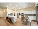 Bright kitchen with stainless steel appliances, granite counters, island, and dining area at 4415 E Weaver Rd, Phoenix, AZ 85050
