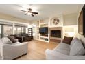 Cozy living room featuring a fireplace, neutral paint, and lots of natural light at 4415 E Weaver Rd, Phoenix, AZ 85050