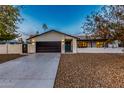 Charming home featuring a well-manicured front yard and a spacious two-car garage at 5112 E Voltaire Ave, Scottsdale, AZ 85254