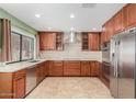 Well-lit kitchen featuring stainless steel appliances and light countertops at 6604 W Evans Dr, Glendale, AZ 85306