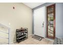 Inviting entryway with tile flooring, shoe rack, and an exterior door with sidelight at 6605 N 93Rd Ave # 1101, Glendale, AZ 85305