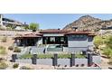 An expansive home exterior with a tiled roof, a pristine backyard pool, and desert landscaping at 6825 N 39Th Pl, Paradise Valley, AZ 85253