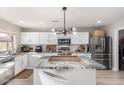 Modern kitchen featuring white cabinets, granite countertops, and stainless steel appliances at 7567 W Andrea Dr, Peoria, AZ 85383