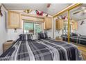 Main bedroom with large bed and mirrored closet doors at 8700 E University Dr # 737, Mesa, AZ 85207