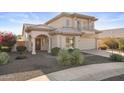 Two-story house with a tan stucco exterior, tile roof, and landscaped yard at 10765 N 119Th St, Scottsdale, AZ 85259