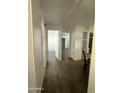 Bright hallway with wood-look floors leads to bedrooms and living areas at 11411 N 91St Ave # 170, Peoria, AZ 85345