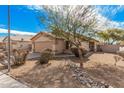 Tan house with a two-car garage and rock landscaping at 11465 W Virginia Ave, Avondale, AZ 85392