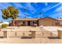 Tan house with a two-car garage and a landscaped front yard at 14409 N 34Th Way, Phoenix, AZ 85032