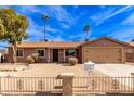 Tan house with a two-car garage and a landscaped front yard at 14409 N 34Th Way, Phoenix, AZ 85032