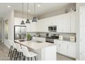 Modern kitchen with white cabinets, granite countertops, and a kitchen island at 15056 W Gray Fox Trl, Surprise, AZ 85387